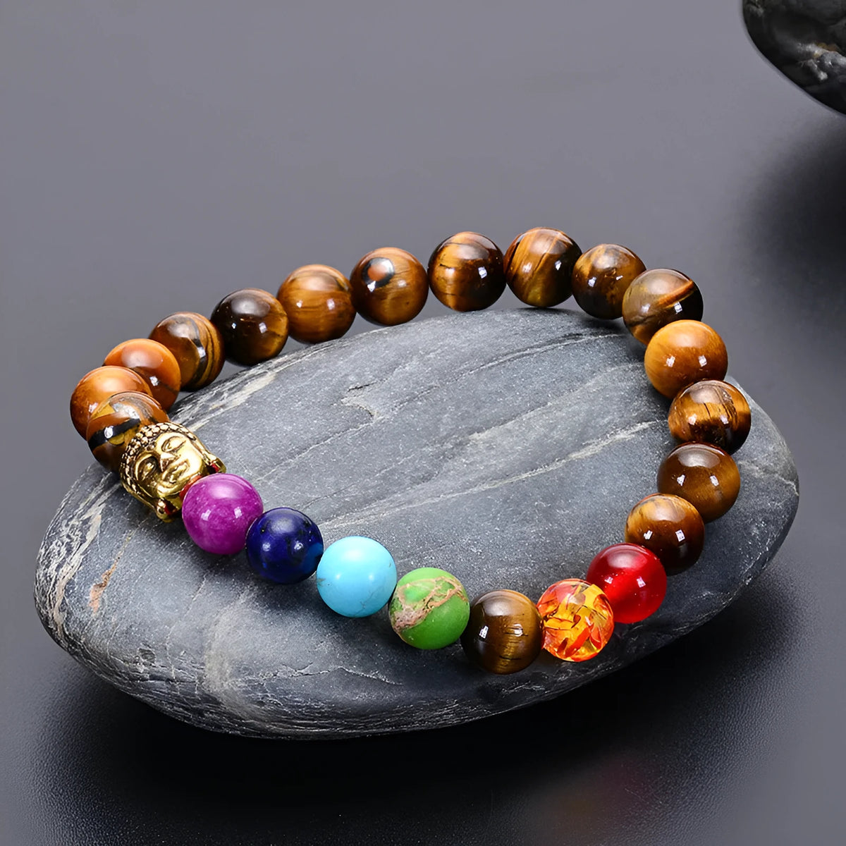 Seven chakra beaded bracelet with natural stone and tiger eye beads, adjustable rope, unisex design.