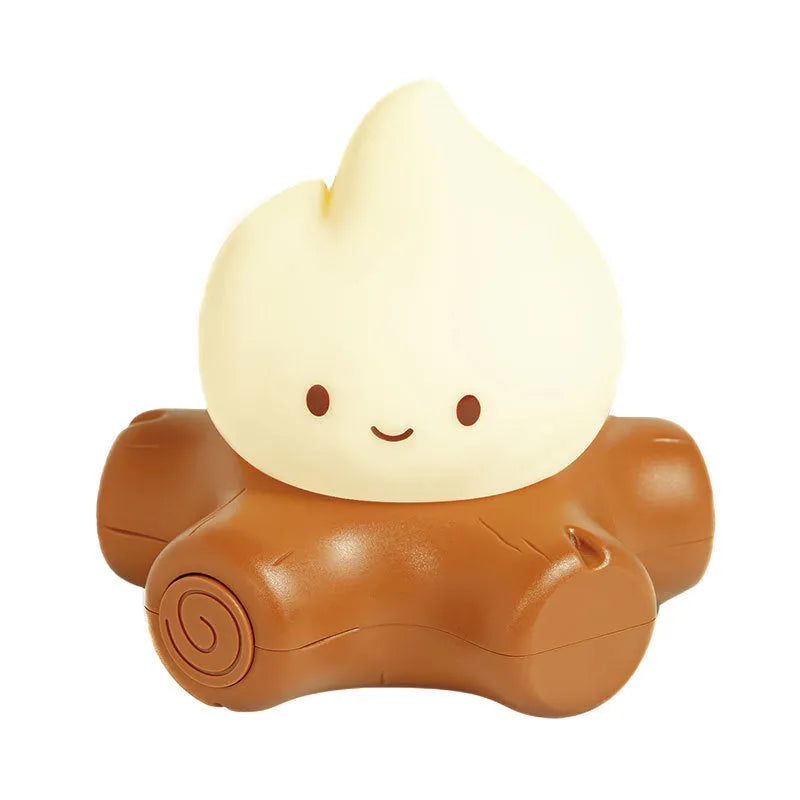 Silicone cartoon fire pile shaped night lamp with yellow glow, shown next to a USB charging cable.