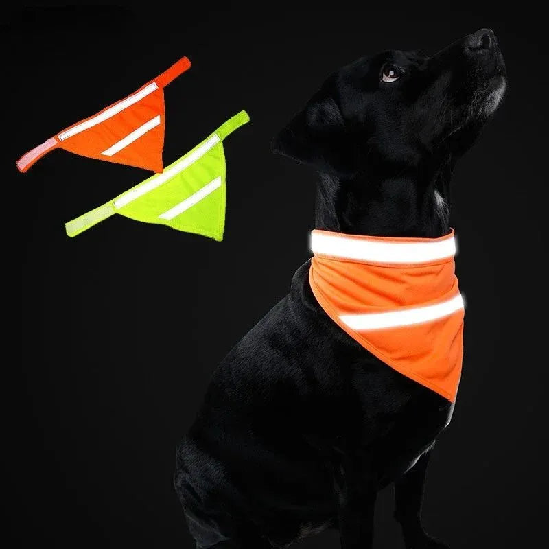 Yellow and orange reflective dog bandana with adhesive strap, shown on a dog's neck.