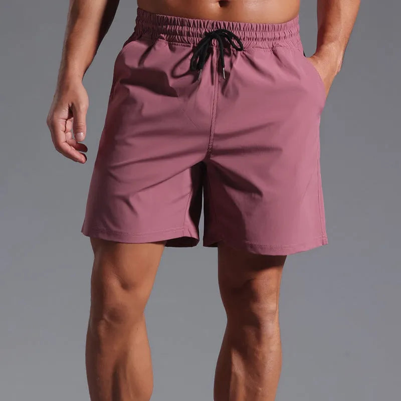Man wearing loose-fitting khaki coloured casual polyester shorts with a straight leg and mid-waist.