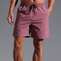 Man wearing loose-fitting khaki coloured casual polyester shorts with a straight leg and mid-waist.