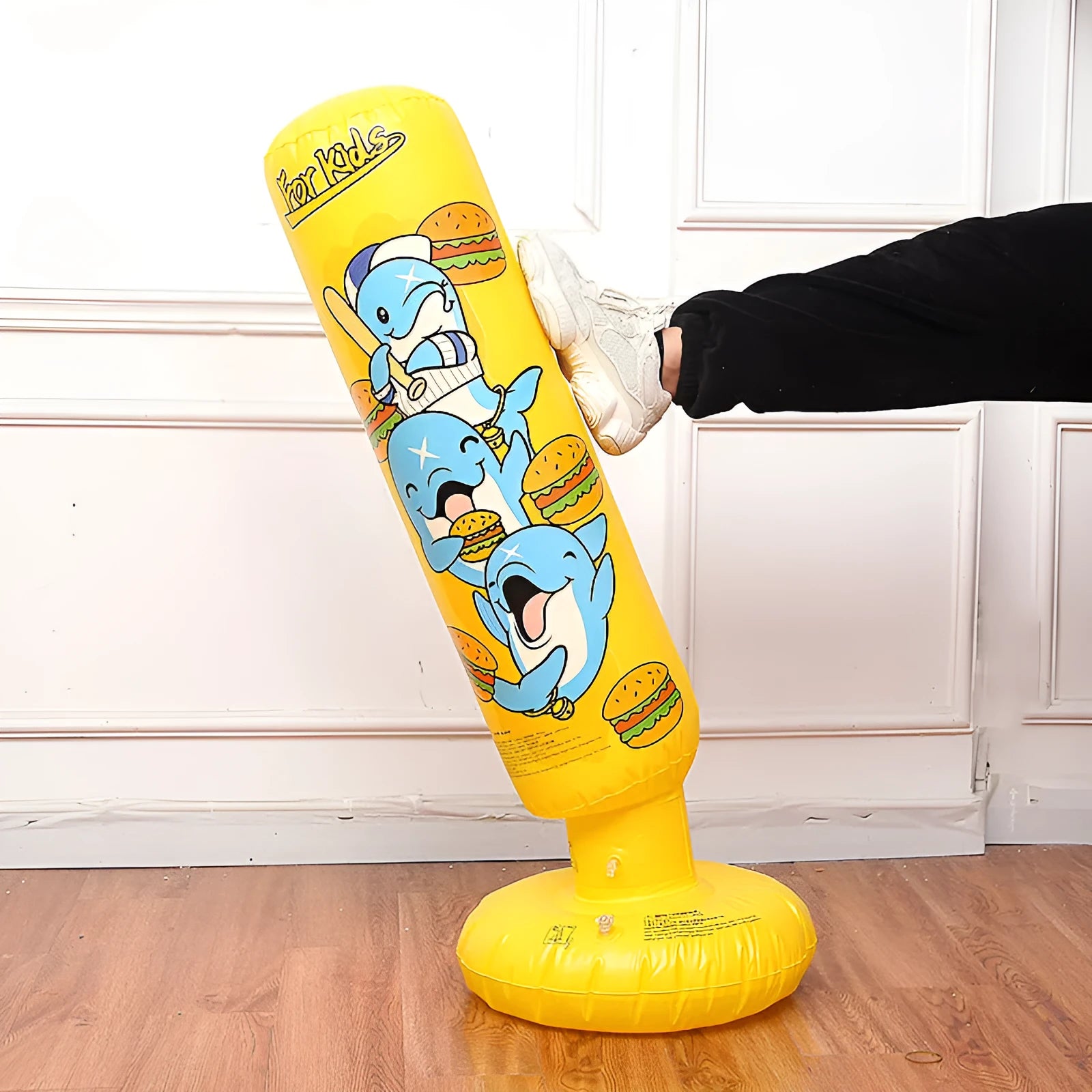 Yellow inflatable boxing column with hamburger print design standing upright.