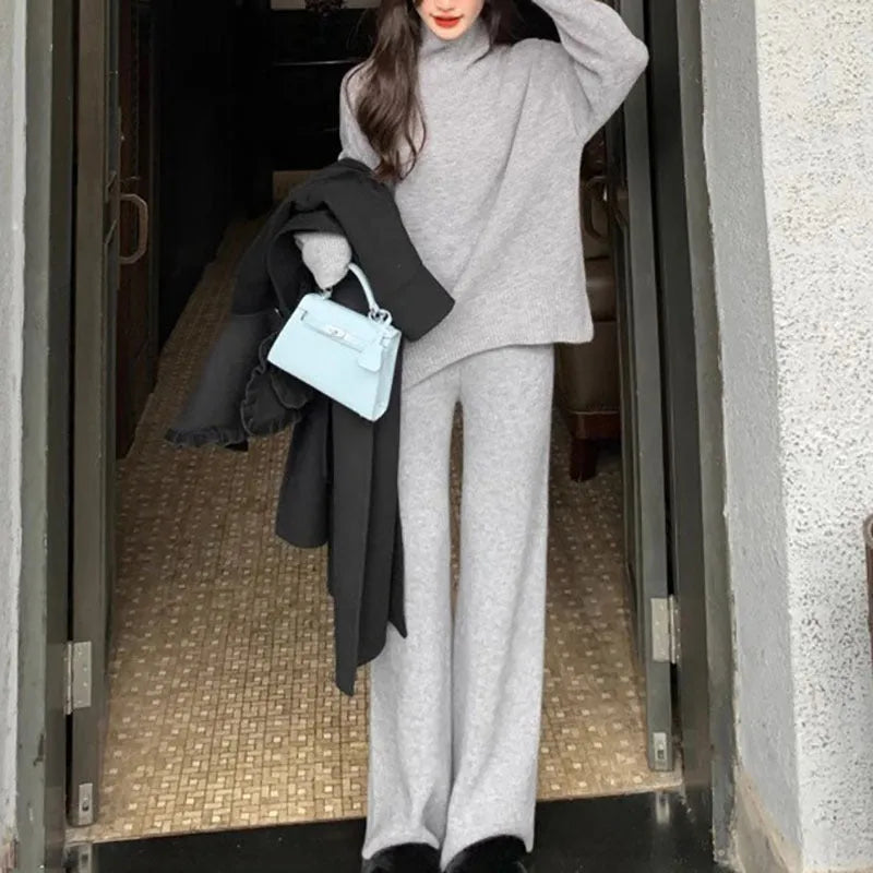 Women's milky white acrylic fibre sweater and wide-leg trousers two-piece casual set on a hanger.