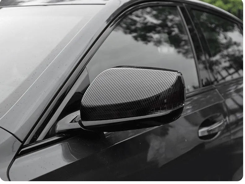 Pair of ABS plastic rearview mirror covers for Cadillac CT5 CT6 in carbon fibre, silver, and rain frame finish options.