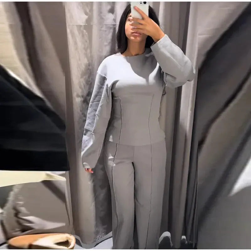 Women's long sleeve polar fleece suit set in apricot colour, showing O-neck top and wide-leg trousers.