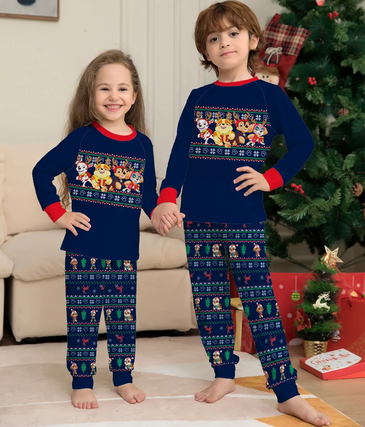 Matching red and black plaid Christmas pyjamas with deer print for men, women, children, and a dog