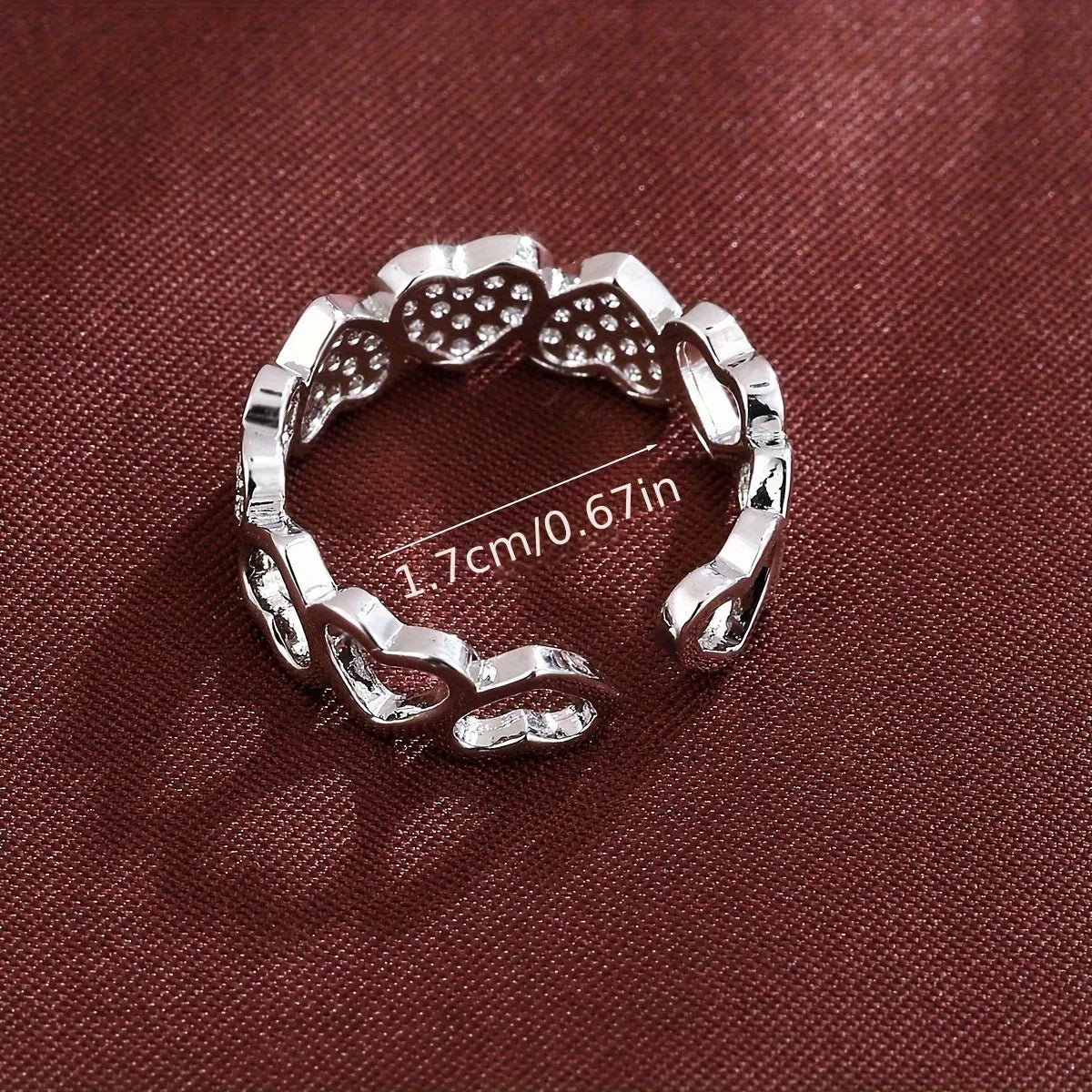 Gold or silver adjustable openable heart-shaped couples ring on a copper base.