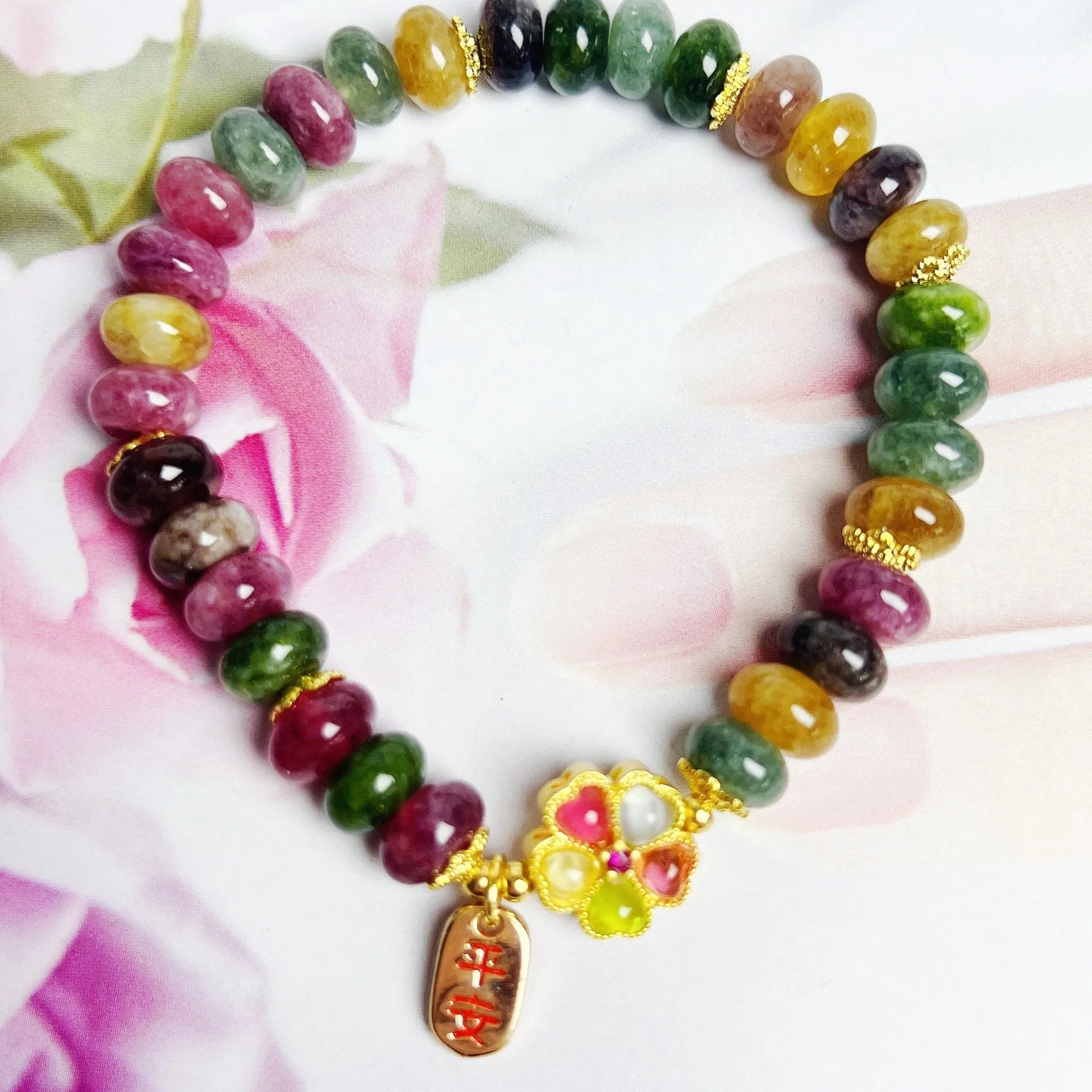 Colourful artificial crystal abacus bead bracelet with tourmaline-style stones on wrist