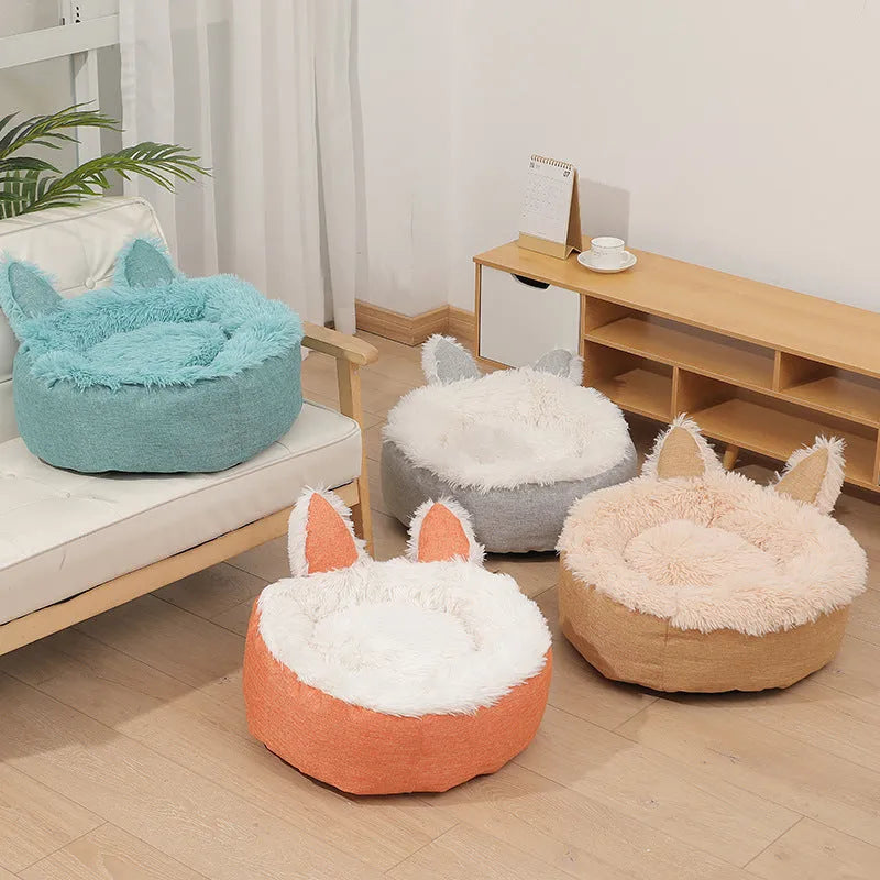 Blue plush faux fur circular cat bed with raised sides on a wooden floor