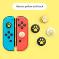Four silicone joystick covers for Nintendo Switch Lite in assorted colours on a grey background.