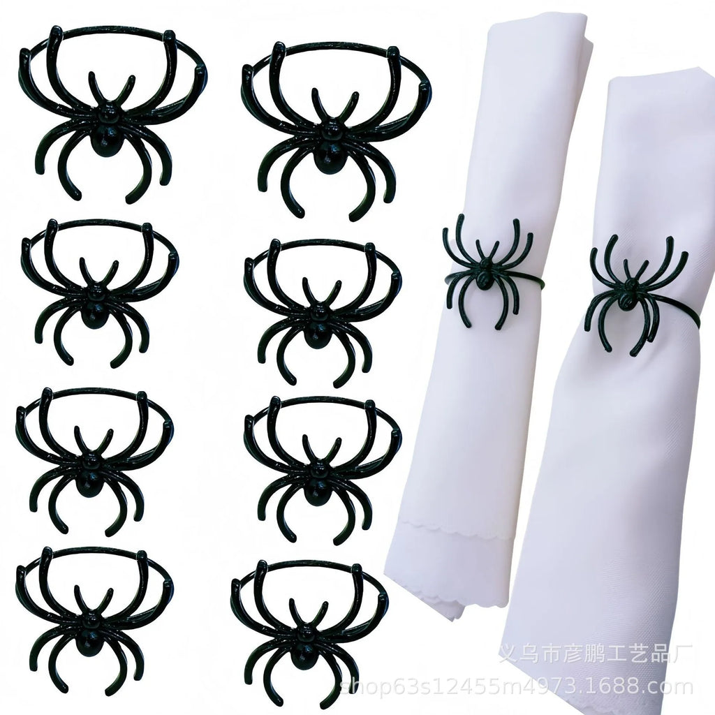 Set of six black metal spider-shaped napkin rings for Halloween table decorations.