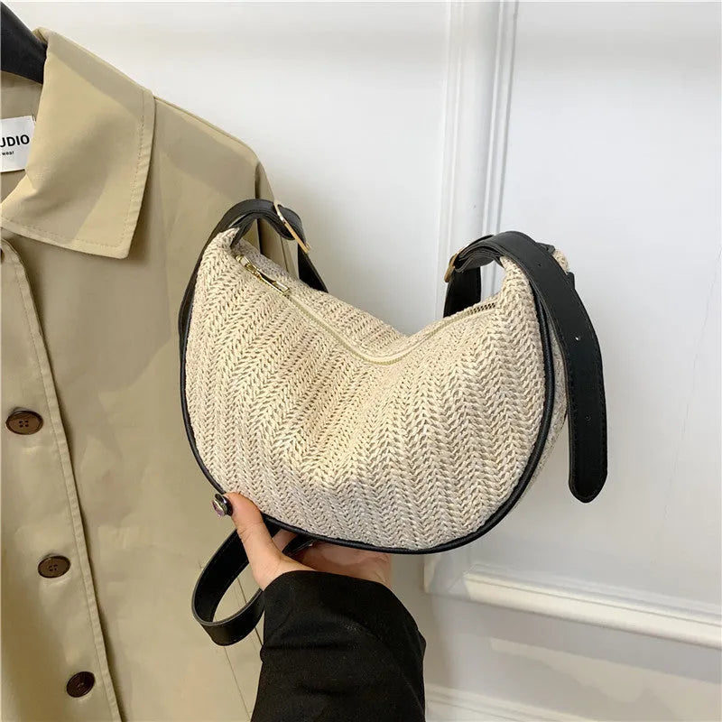 Women's woven straw crossbody bag showing textured surface with phone and file compartments inside