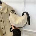 Women's woven straw crossbody bag showing textured surface with phone and file compartments inside