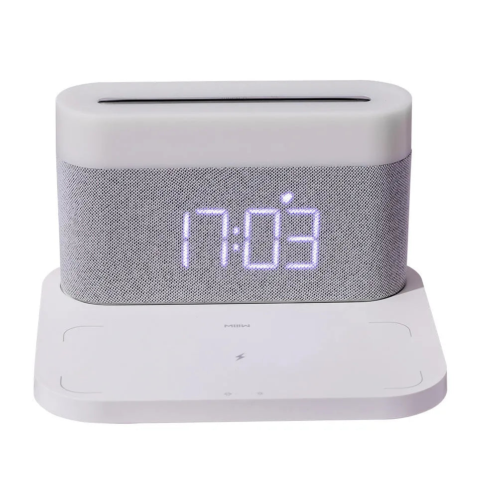 Black or white table lamp with integrated wireless phone charger, LED clock display, and nightlight functions