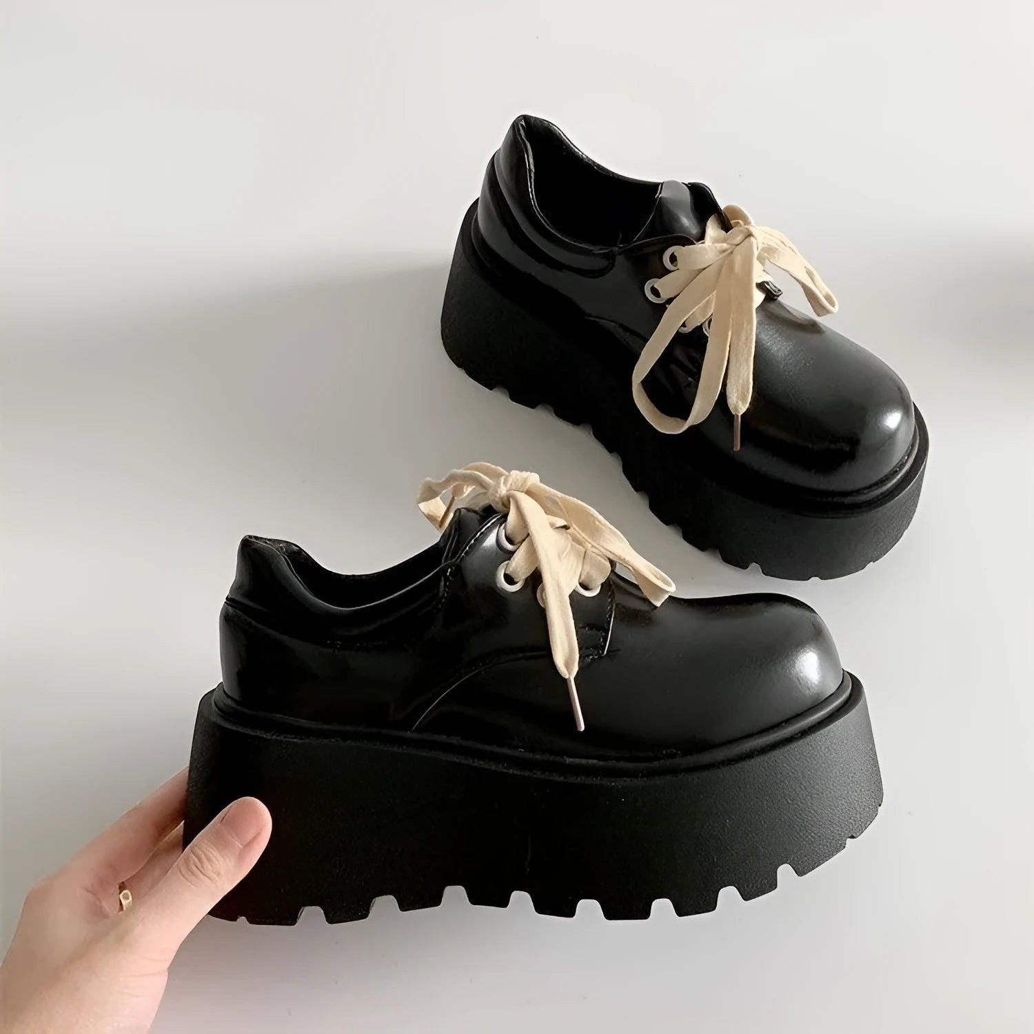 Women's matte black lace-up platform ankle boots with a thick sole and round toe.