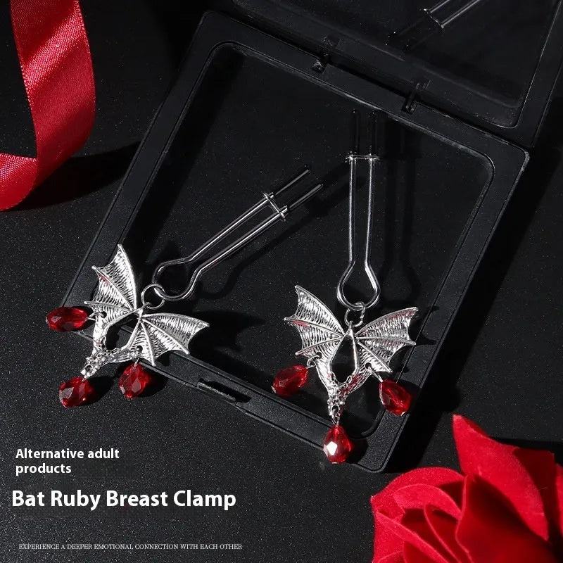 Silver bat nipple clamp with ruby detail and adjustable mechanism