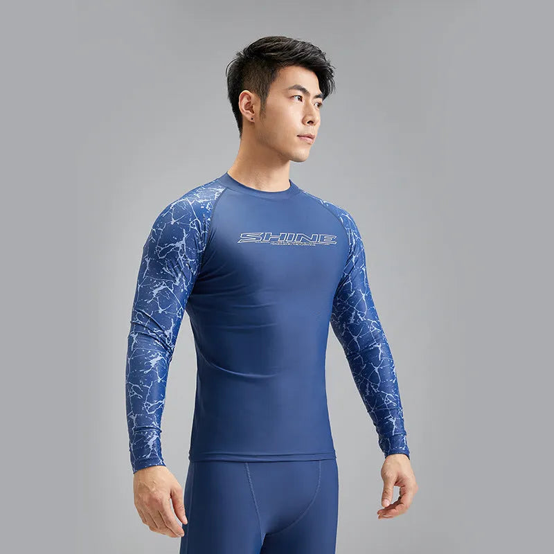 Men's dark blue patterned nylon swimwear set consisting of a top and trousers.