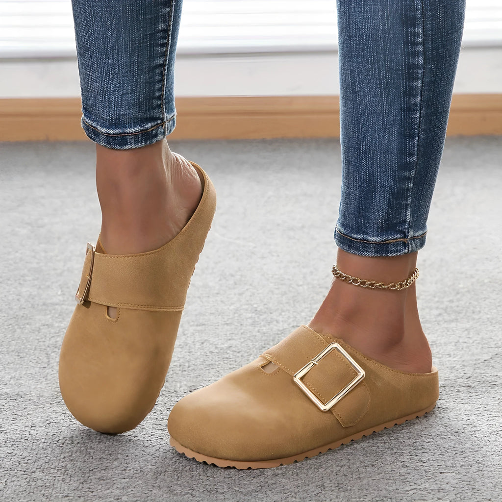Women's brown closed toe low top canvas slippers shown from the side.