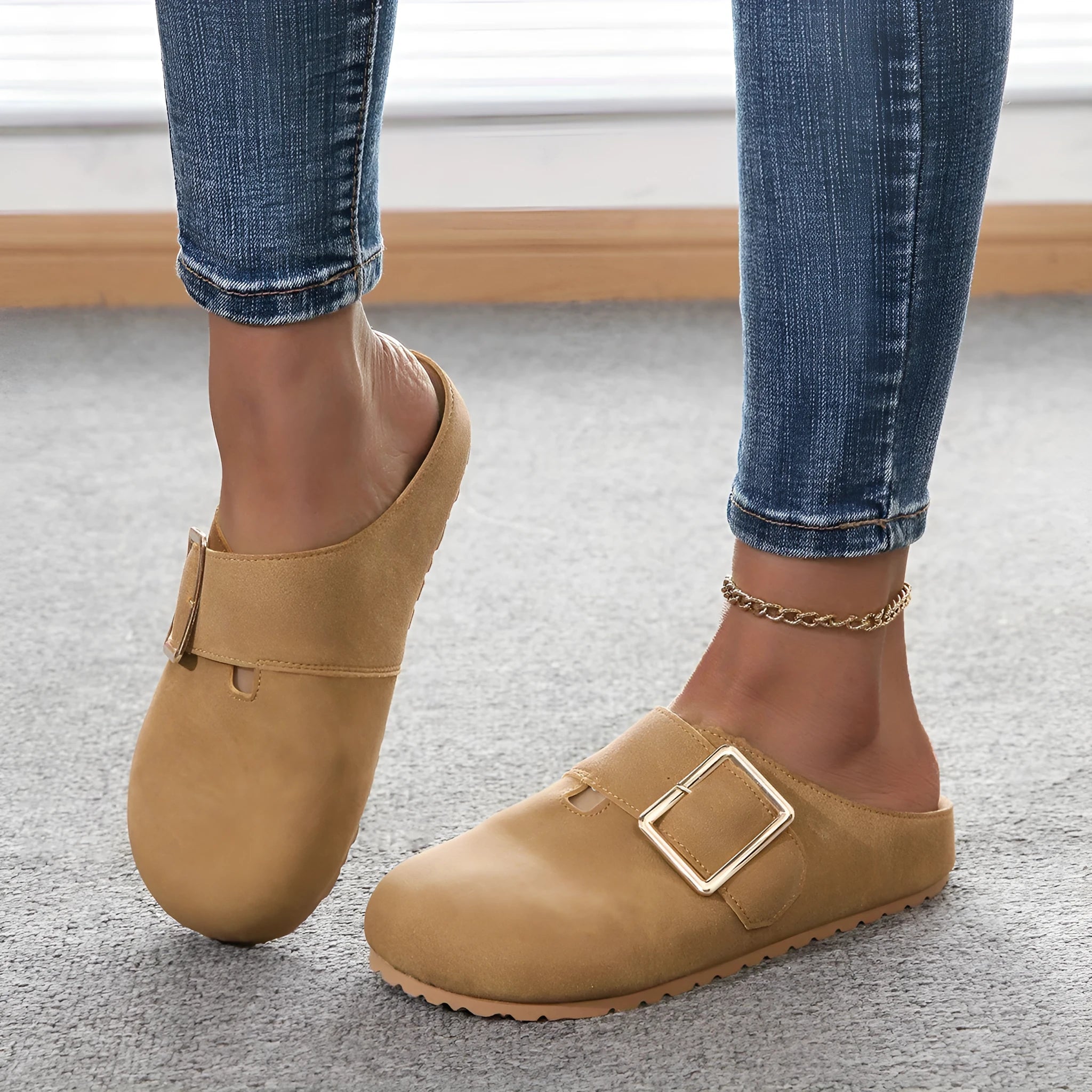 Women's brown closed toe low top canvas slippers shown from the side.