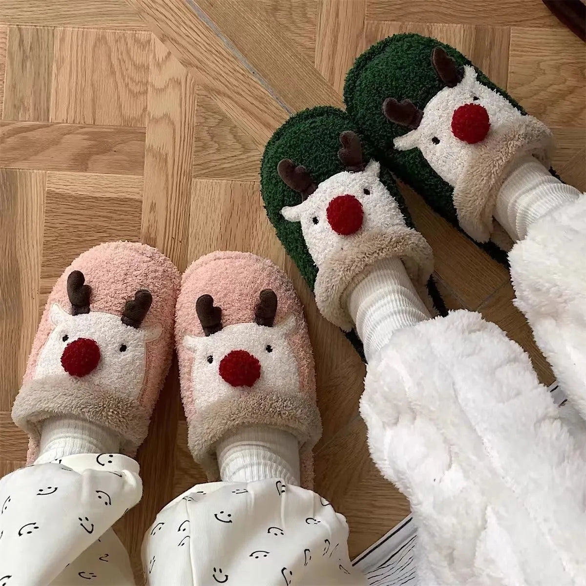 Women's brown Christmas elk plush slippers with non-slip PVC sole on a wooden floor.