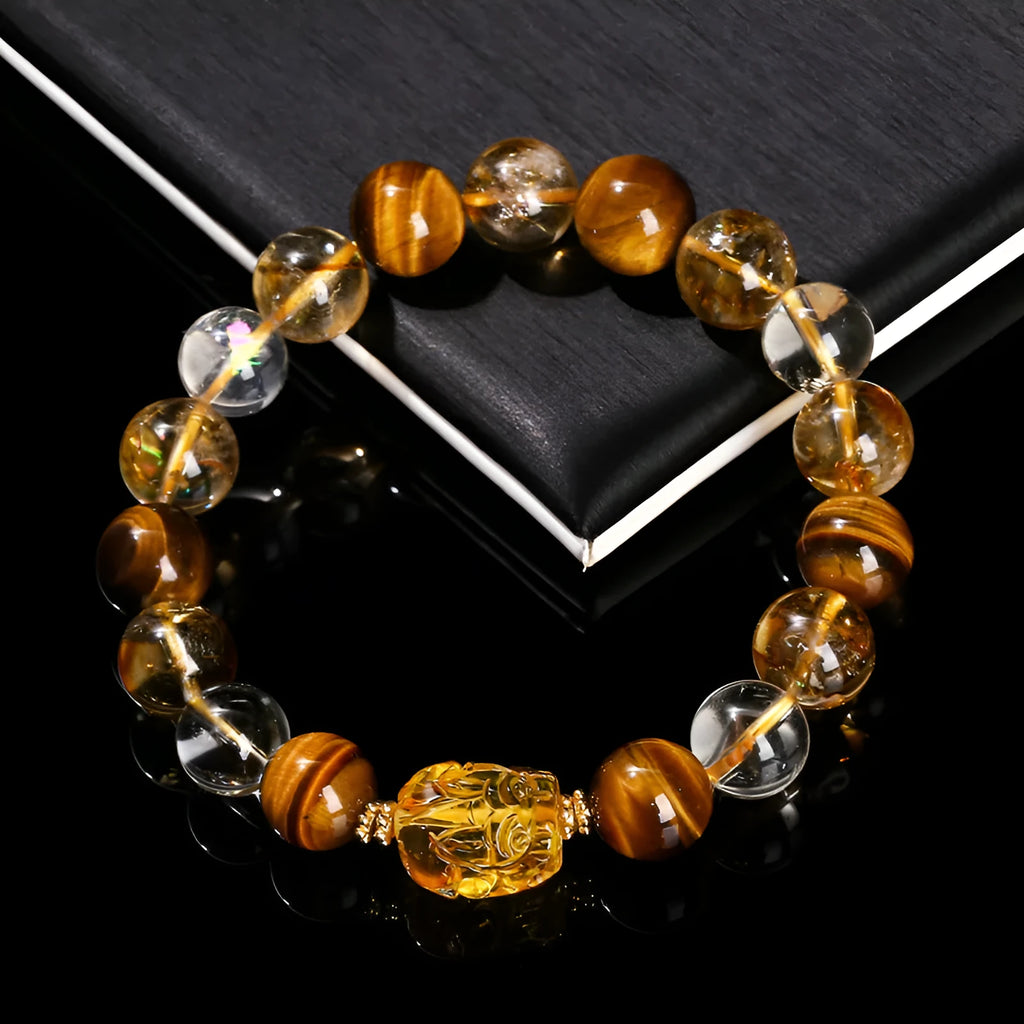 Close-up of a unisex bracelet with 10mm yellow tiger's eye and citrine round beads and a detailed beeswax pi xiu charm.