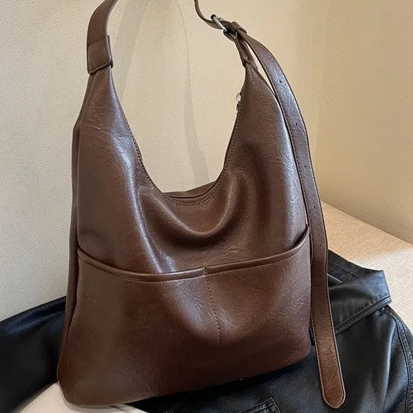 Women's large-capacity PU crossbody bag in coffee or black, 25cm high, 30cm wide, 12cm thick, with small bag.