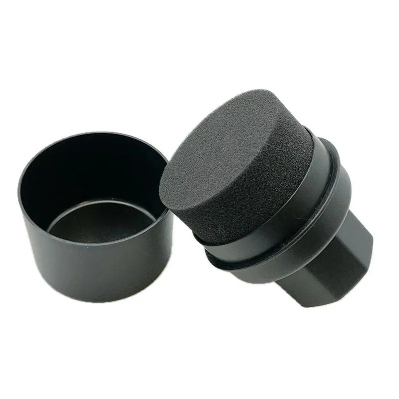 Black and red tyre oil sponge brushes with lids on a white background.