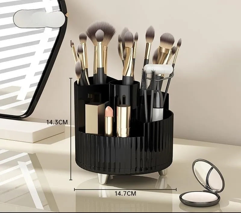 Rotating cream and black cosmetics organiser box holding makeup brushes and lipsticks on a table.