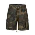 Men's green washed camouflage cotton workwear shorts with a loose fit on a mid-waist.