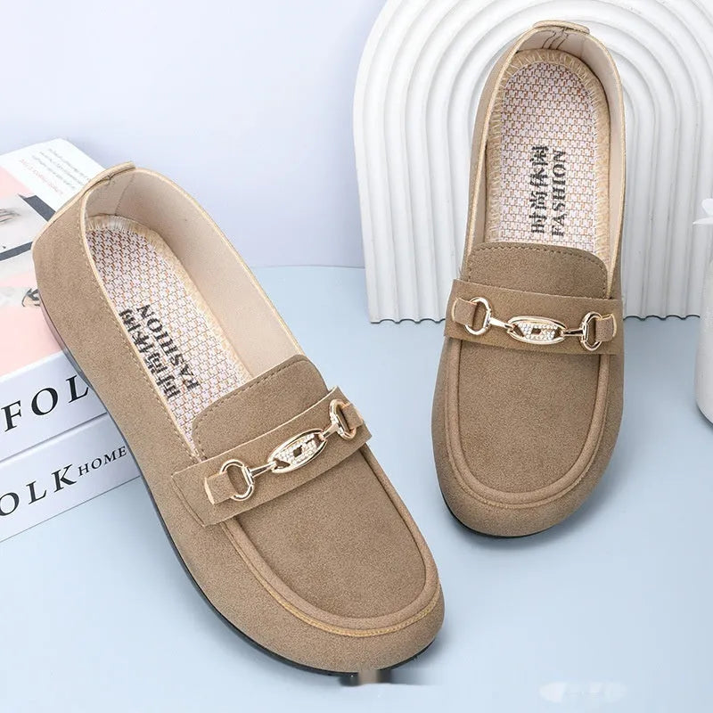 Gommino women's black slip-on casual shoes with a round toe and soft rubber sole on a white background.