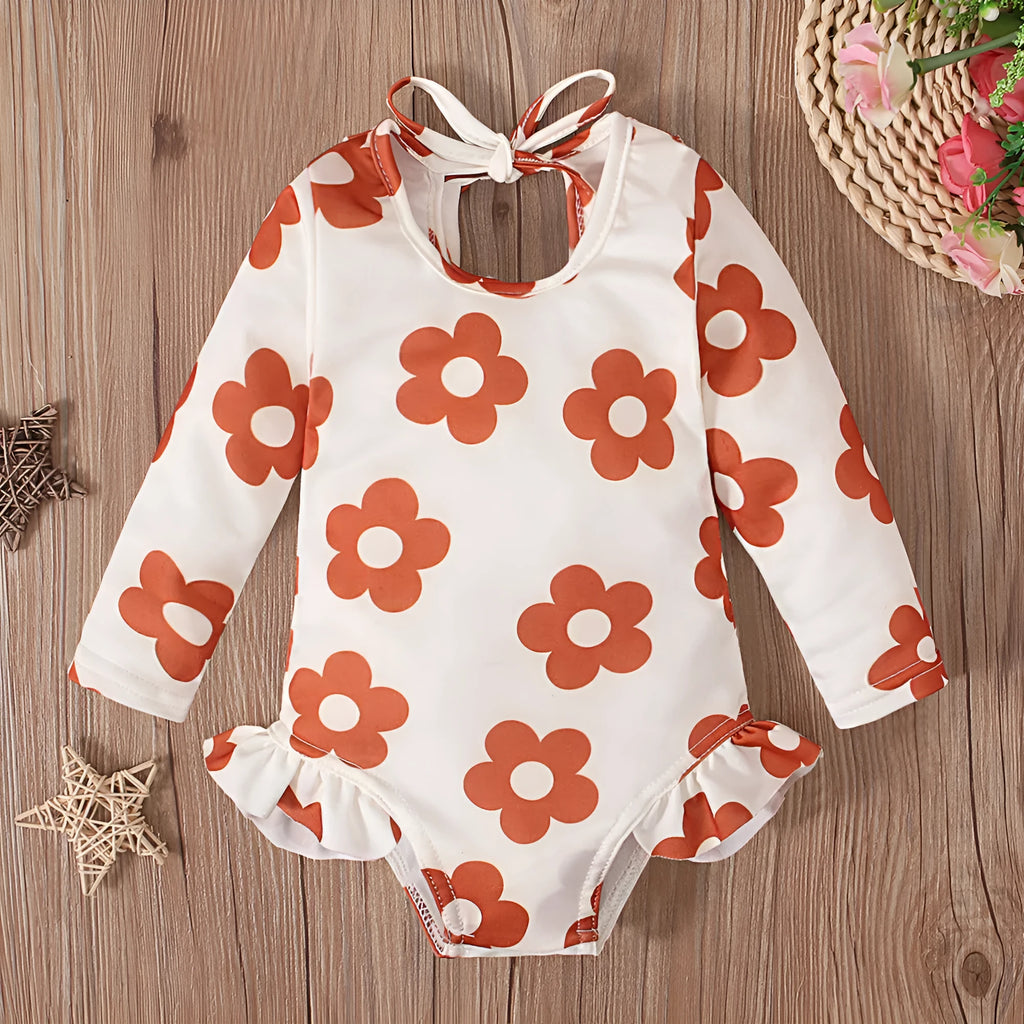 Girl's floral print open back swimsuit in orange red, shown from front and back.