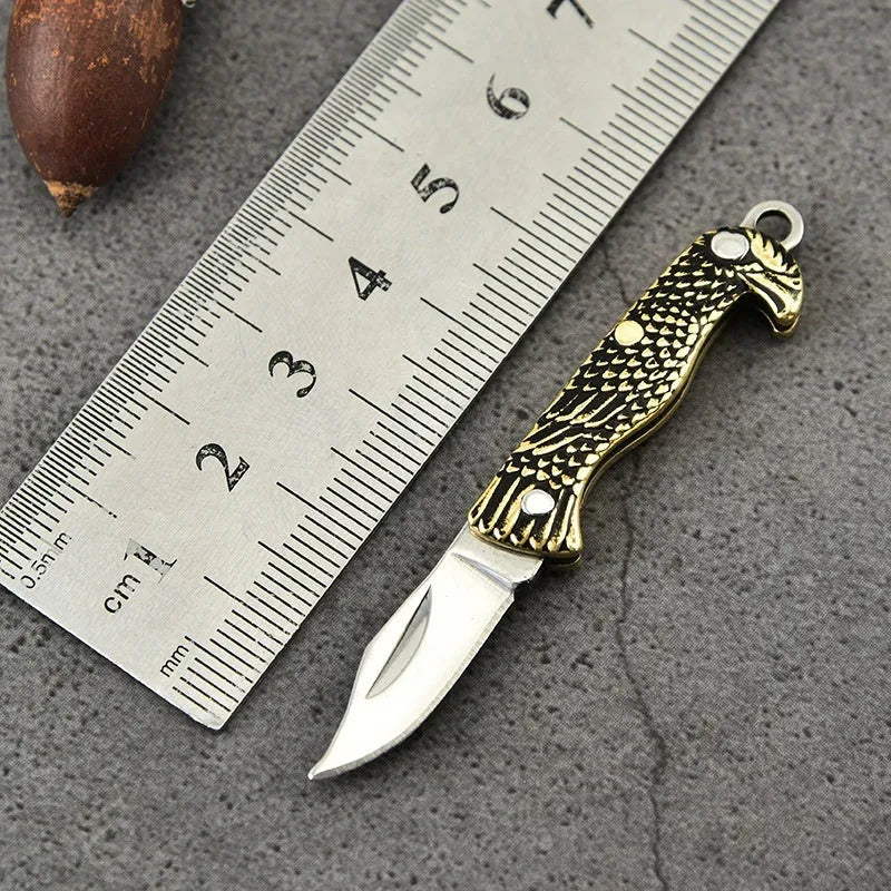 Brass mini folding knife keychain pendant with 3cm blade and 50mm or 60mm full length in five brass handle styles.