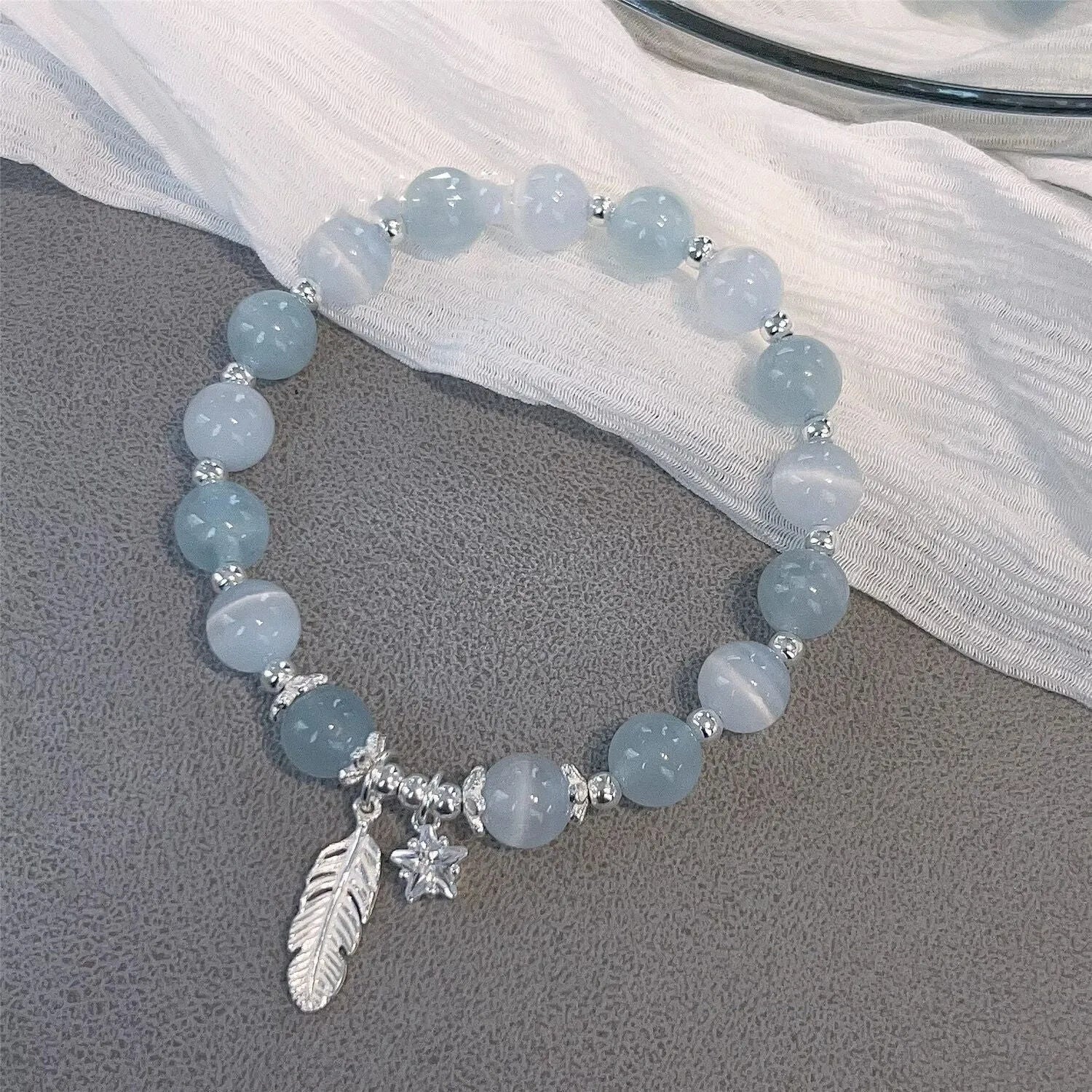 Korean style crystal bracelet with feather XINGX blue moonlight colour and eight Awn star design