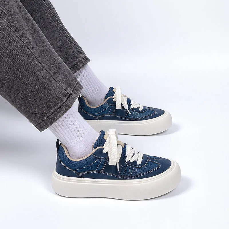 Men's black platform canvas trainers with lace-up front and raised sole on a white background