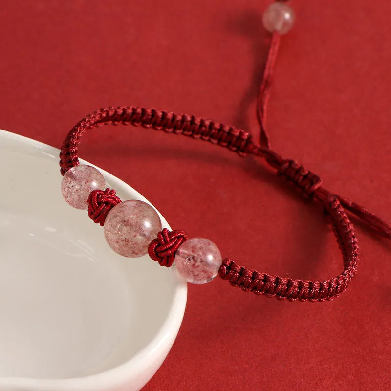 Natural strawberry quartz beaded bracelet on woven red rope with alloy clasp