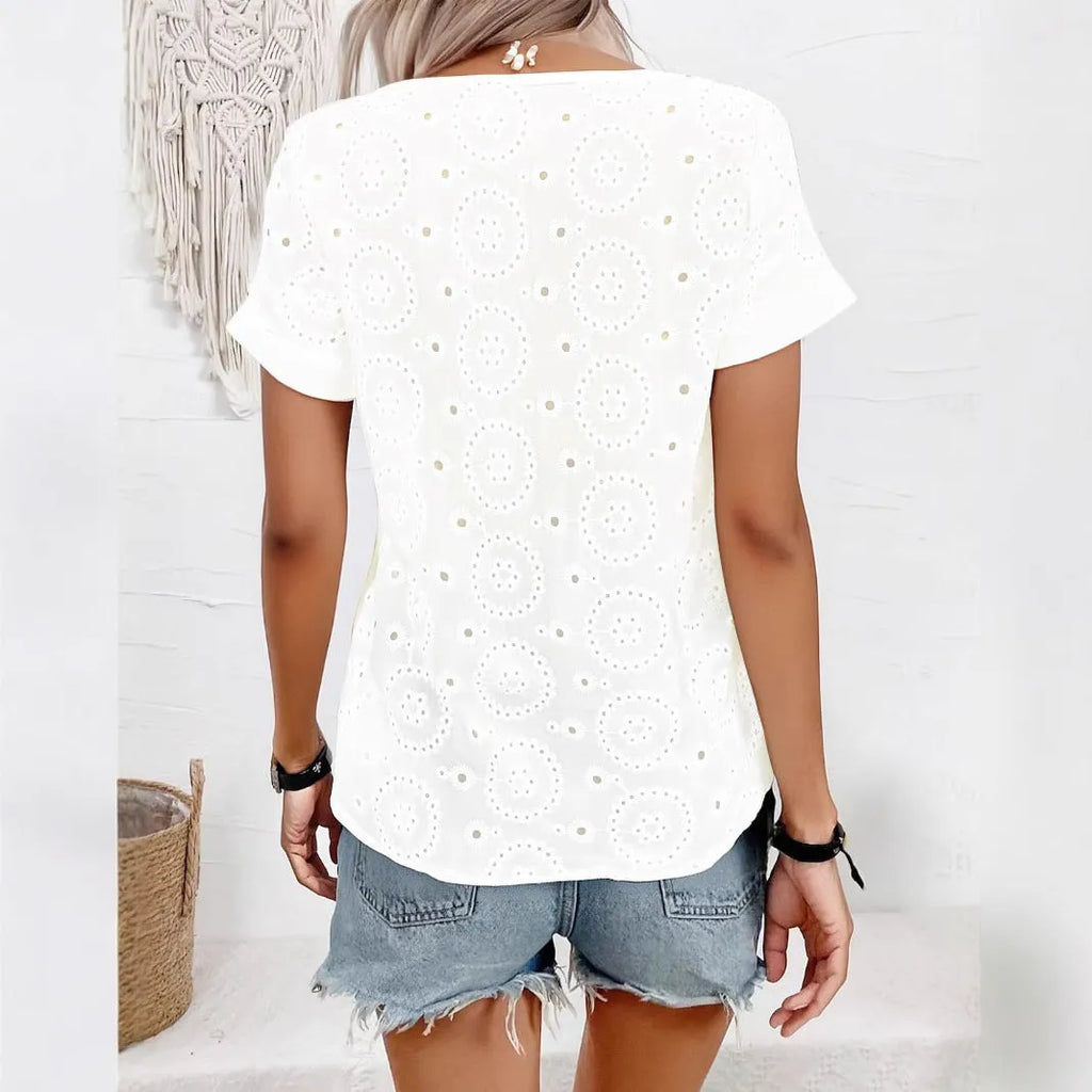 White women's loose fit T-shirt with a V-neck, short sleeves, and a hollow-out pattern detail.
