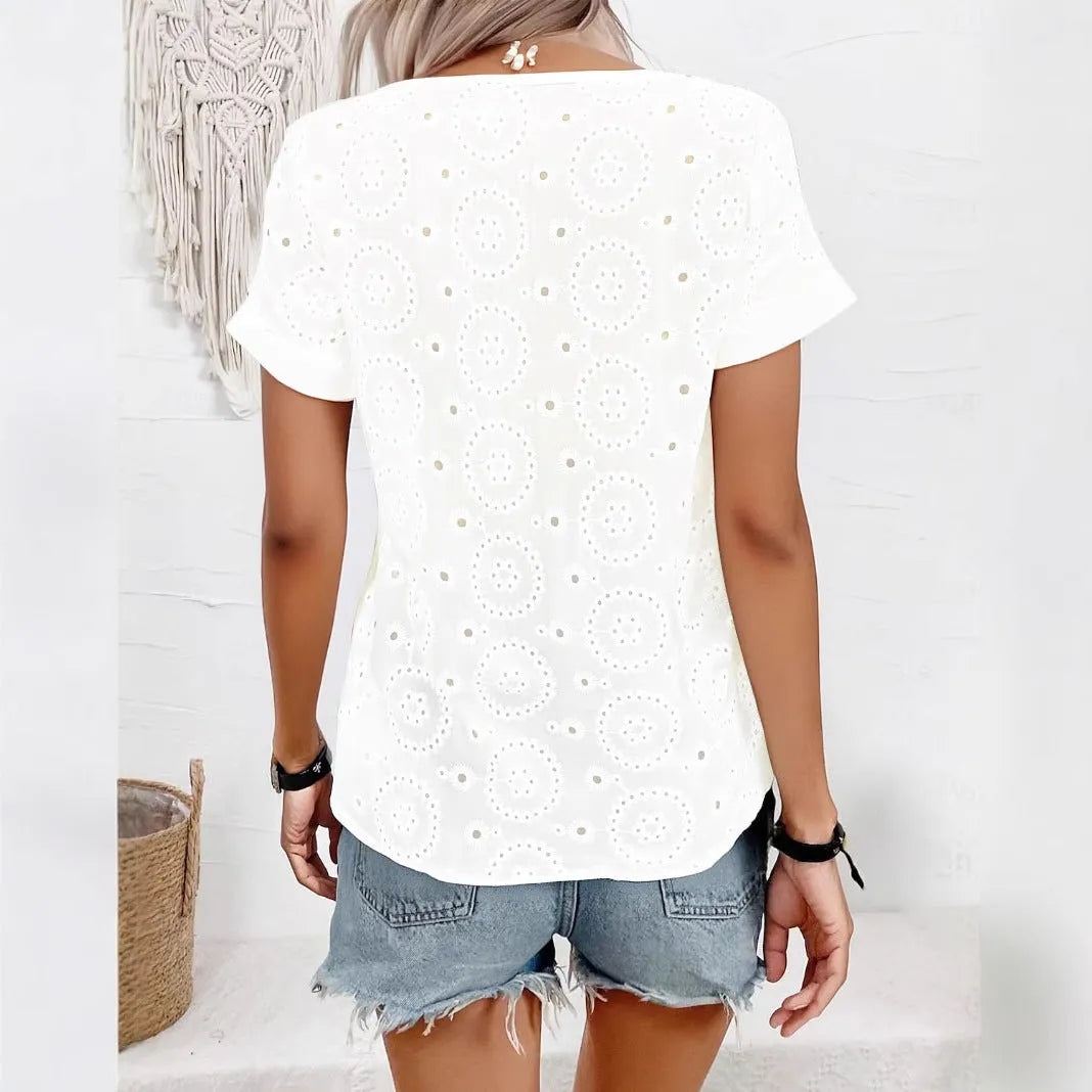 White women's loose fit T-shirt with a V-neck, short sleeves, and a hollow-out pattern detail.