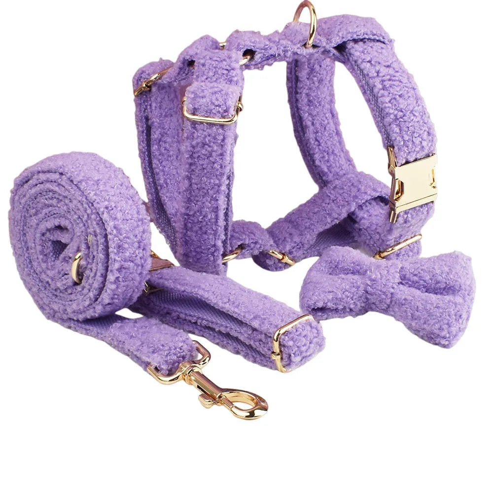 Purple cloth dog collar, lead, bow, and vest set laid out flat, showing the four matching accessories.