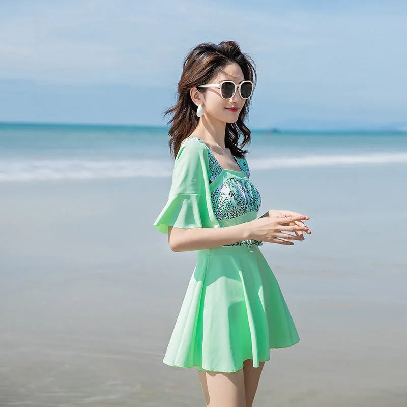 Women's blue and green printed one-piece swimsuit with seaside pattern