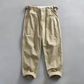 Men's straight-leg cotton casual trousers in apricot, shown flat.