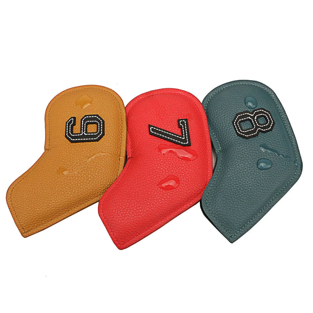 Set of 10 assorted coloured PU leather golf club head covers on a green background.