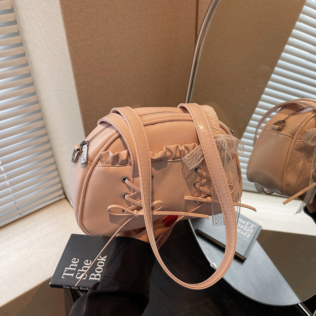 Women's PU leather handbag with bandage bow detail showing internal mobile phone pocket