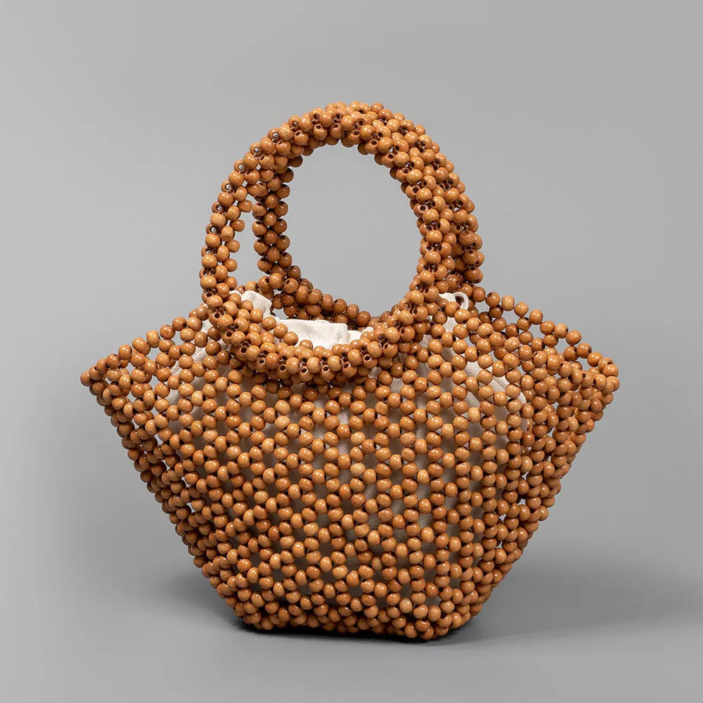 Hand-woven maple wood beach bag with wooden bead decoration in dumpling shape