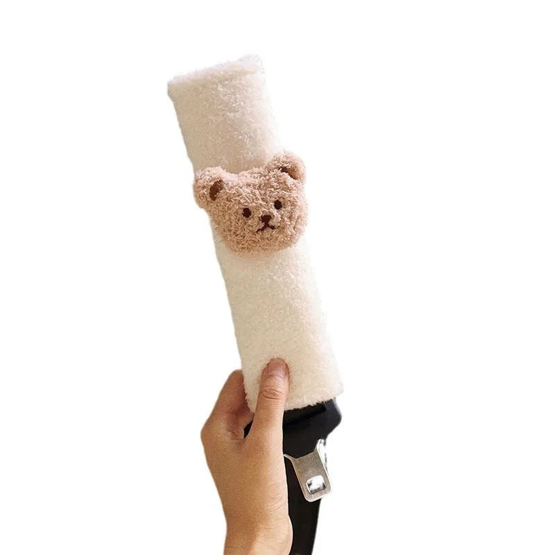 Cartoon bear plush seat belt shoulder cover for child car safety measuring 25cm by 6.5cm by 5cm.