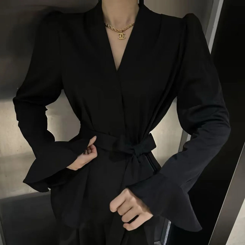 Women's black polyester shirt with a French-style irregular collar and long bell sleeves.