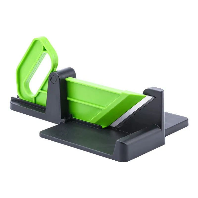 Green vegetable cutter with stainless steel blades for carrot and potato slicing in kitchen