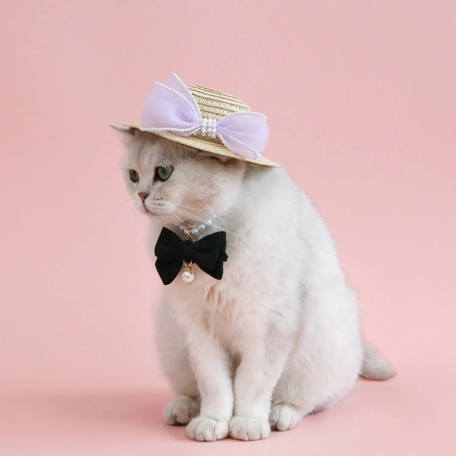 Pink pearl bow woven straw hat for a cat, shown in a princess style on a blank background.