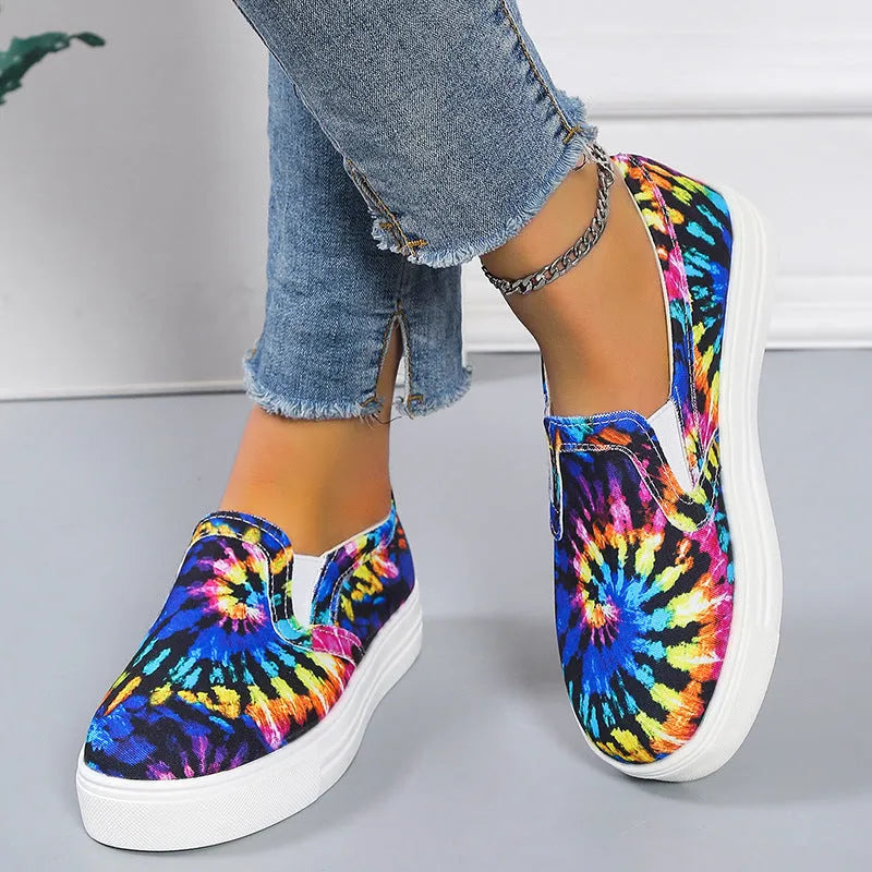 Women's blue colour match canvas trainers with flat rubber sole on a white background.