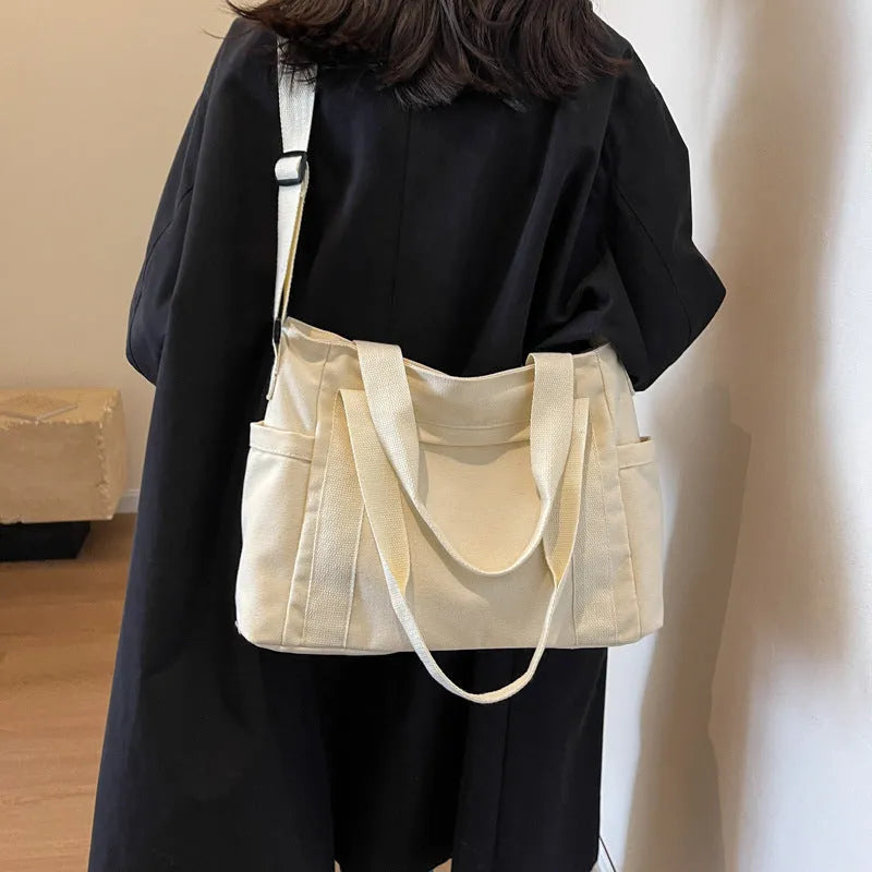 Large canvas shoulder tote bag in solid colour with sandwich pocket organisation