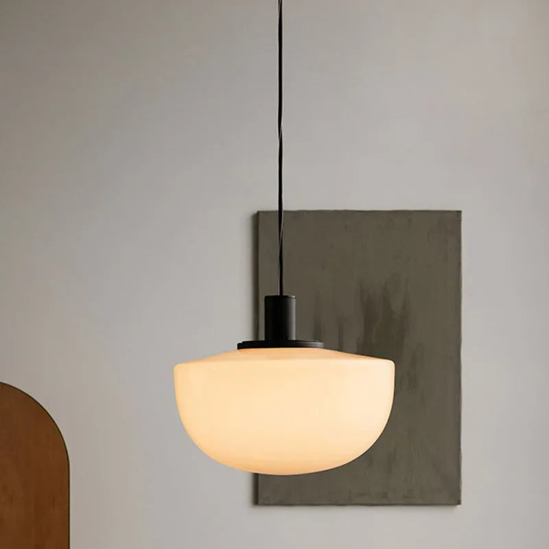 Simple modern milky white glass single-head pendant light suspended from ceiling